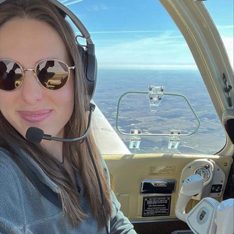 woman flying an airplane in baia