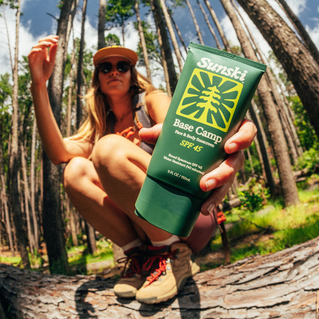 Base Camp SPF 45 Sunscreen - 5 Fl oz / 150 mL - a woman holding Base Camp SPF 45 sunscreen