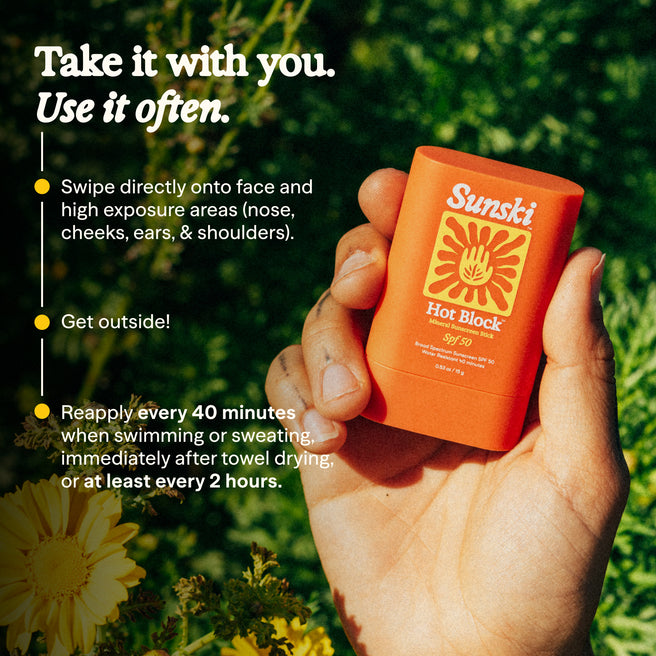 Hot Block SPF 50 Sunscreen - 0.53 oz / 15 g - Hand holding a Sunski sunscreen stick with application instructions on a natural background