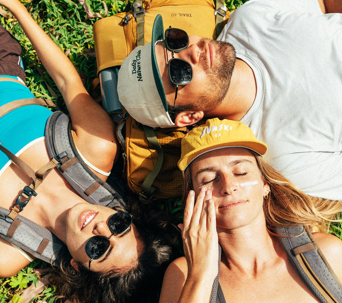 Adventurer feeling Sunski sunscreen on their skin outdoors
