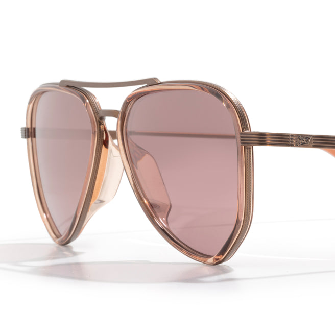 Rose gold sunglasses with pink lenses on a white background