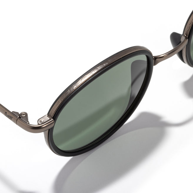 Sunglasses with green lenses and brown frame on a white background
