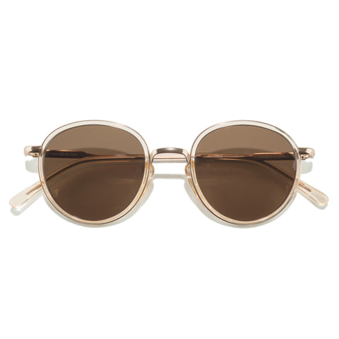 Baia - Champagne Amber - Round sunglasses with gold frame and brown lenses on a white background
