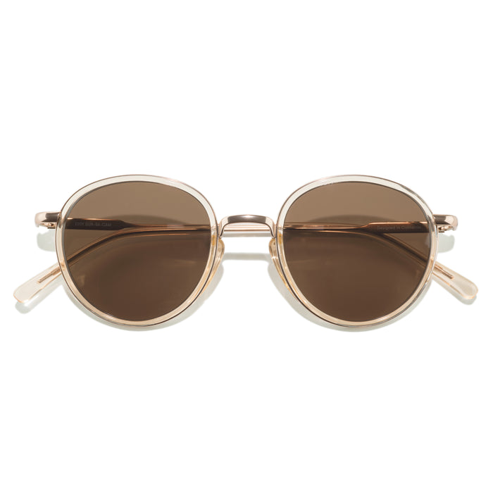 Round sunglasses with gold frame and brown lenses on a white background