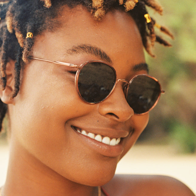 Woman wearing sunglasses with a blurred natural background