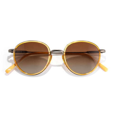 Baia - Honey Sepia - Round sunglasses with gold frames and brown lenses on a white background