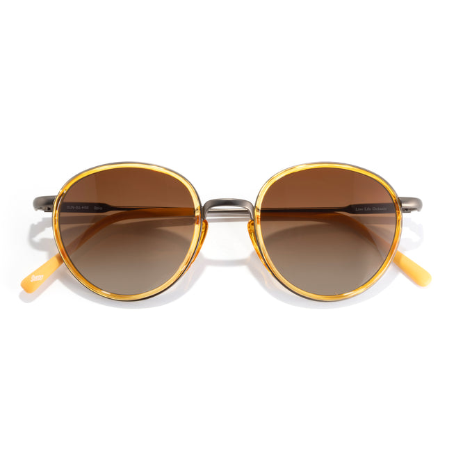 Round sunglasses with gold frames and brown lenses on a white background