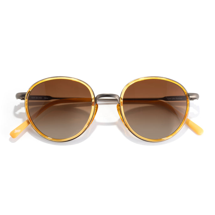 Baia - Honey Sepia - Round sunglasses with gold frames and brown lenses on a white background