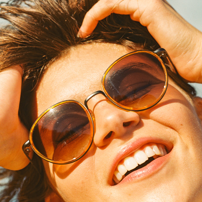 Person wearing sunglasses with a blurred background