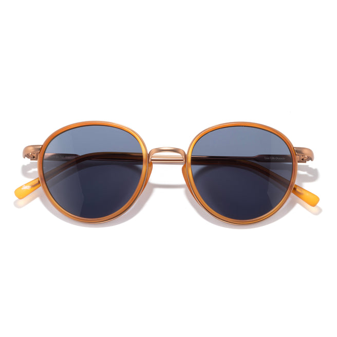 Round sunglasses with gold frame and dark lenses on a white background