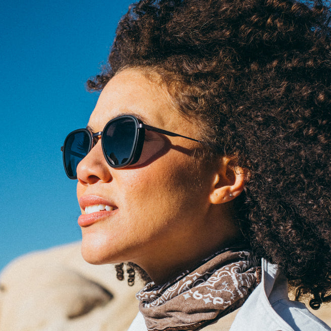 Woman wearing sunglasses with a clear blue sky background