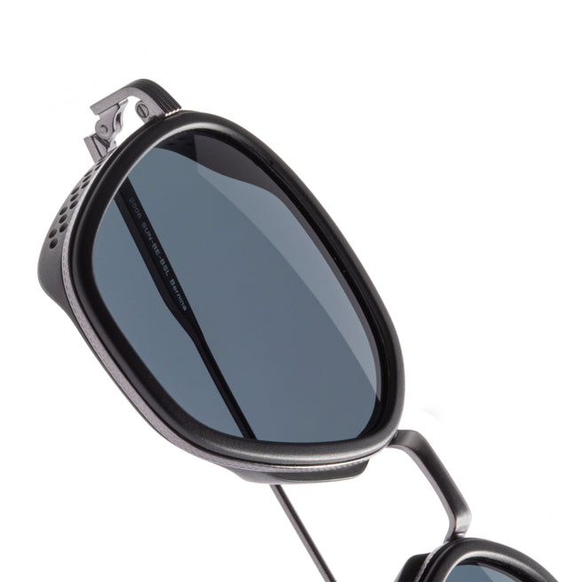Sunglasses with a reflective lens on a white background