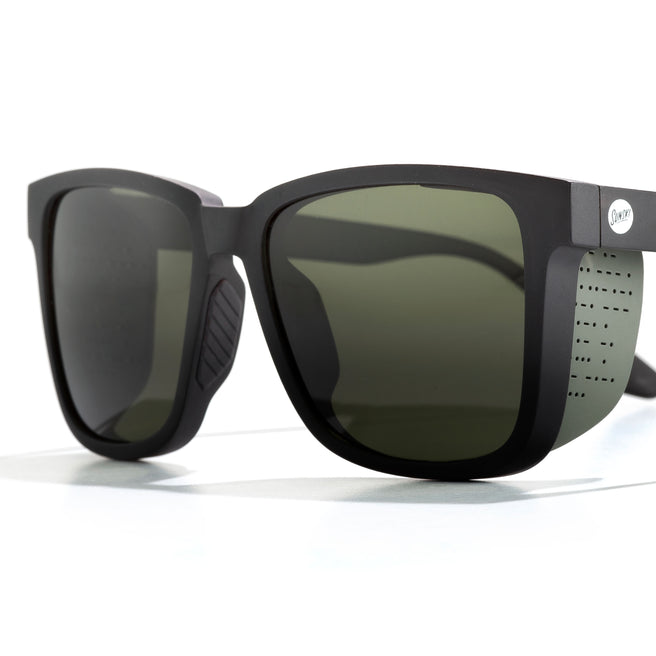 Sunglasses with dark lenses and black frame on a white background