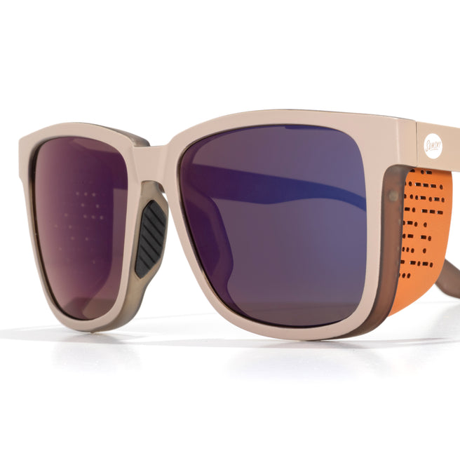 Sunglasses with a beige frame and purple lenses on a white background