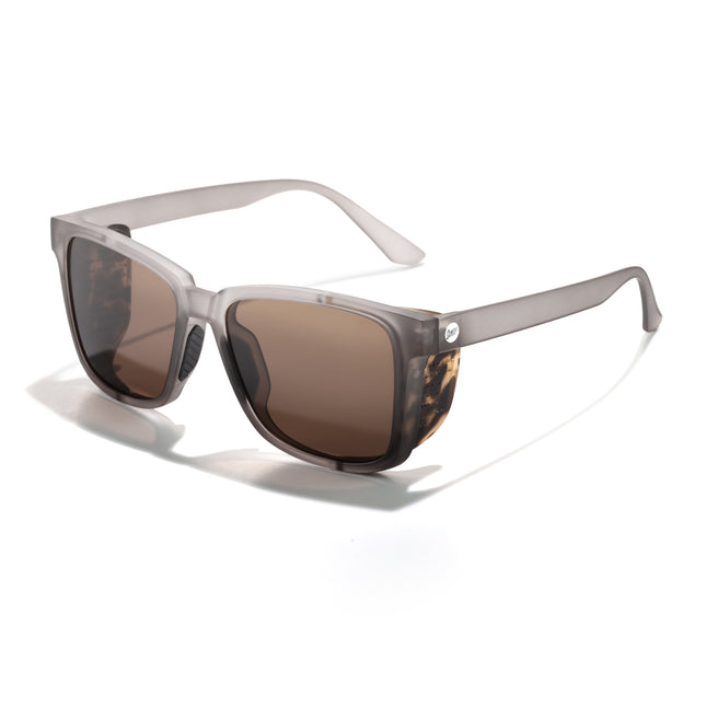 Sunglasses with tortoiseshell frame and brown lenses on a white background