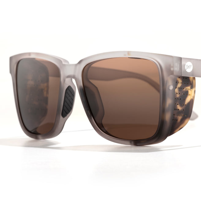 Sunglasses with tortoiseshell frame and brown lenses on a white background