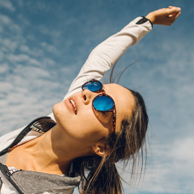 Woman wearing sunglasses with a blue sky background