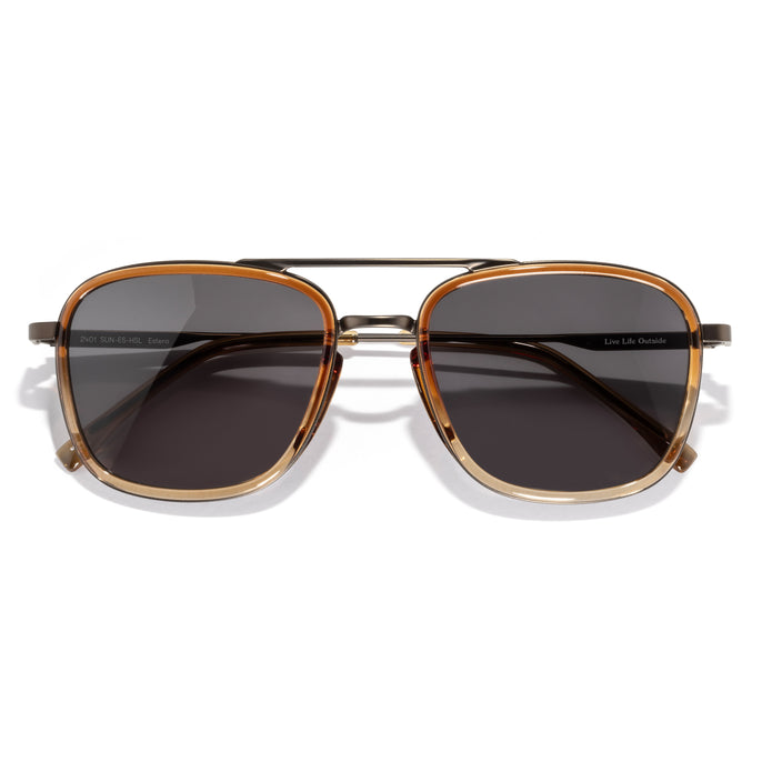 Estero - Horizon Slate - Sunglasses with gold frame and dark lenses on a white background