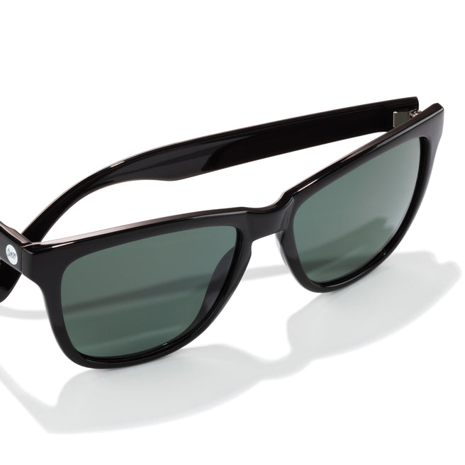 Black sunglasses with dark lenses on a white background