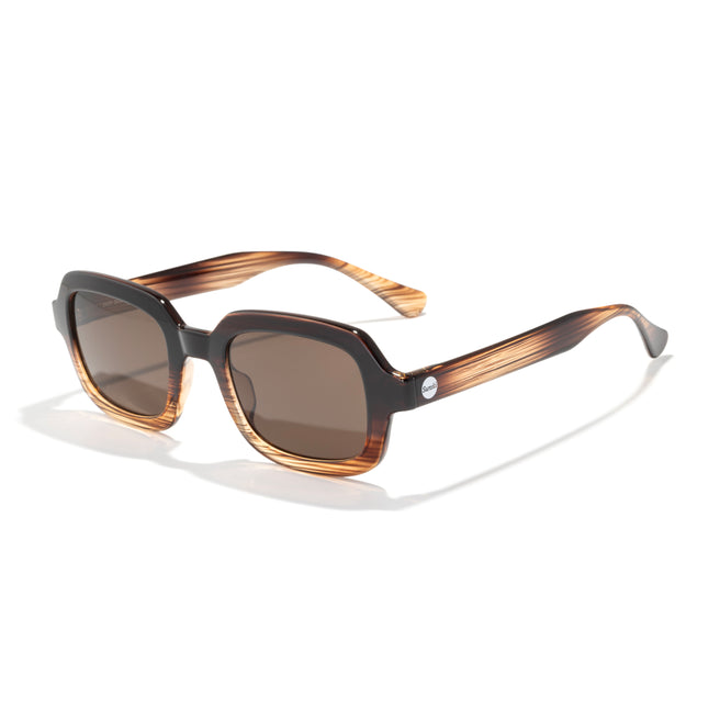 Sunglasses with brown gradient lenses and a striped frame on a white background