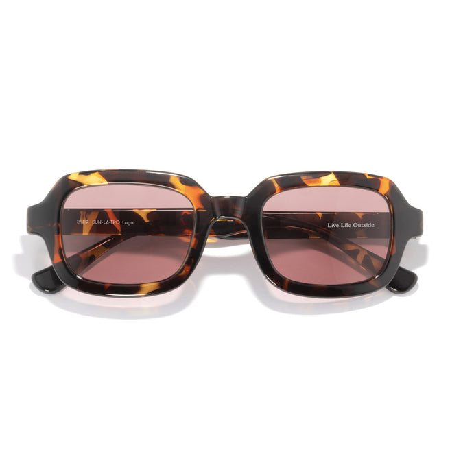 Sunglasses with tortoiseshell frame and pink lenses on a white background
