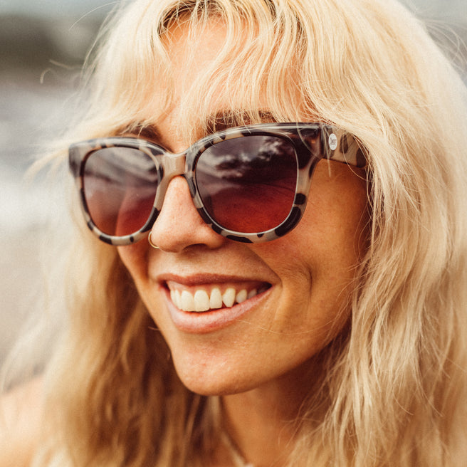 Woman wearing sunglasses with a blurred background