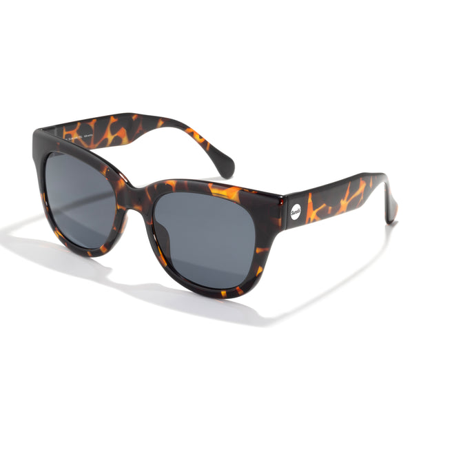 Sunglasses with tortoiseshell frame and dark lenses on a white background