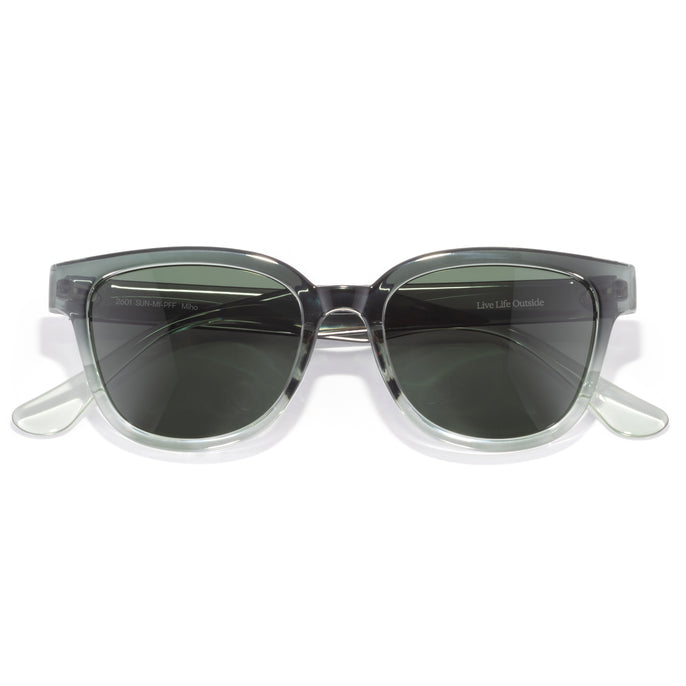 Miho - Pine Fade Forest - Sunglasses with clear frame and dark lenses on a white background