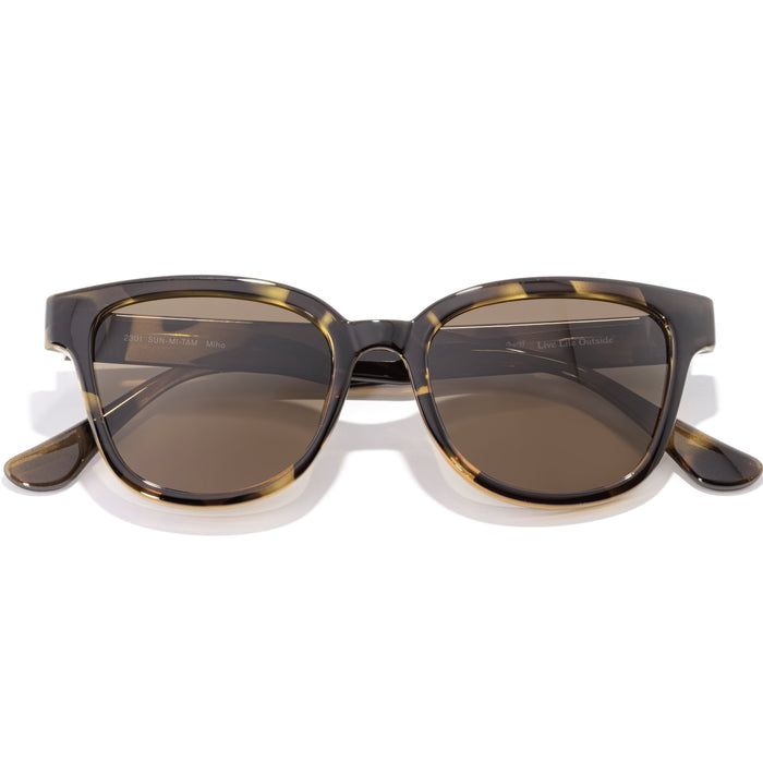 Sunglasses with tortoiseshell frame and brown lenses on a white background