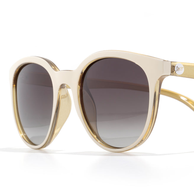 Gold-framed sunglasses with dark lenses on a white background