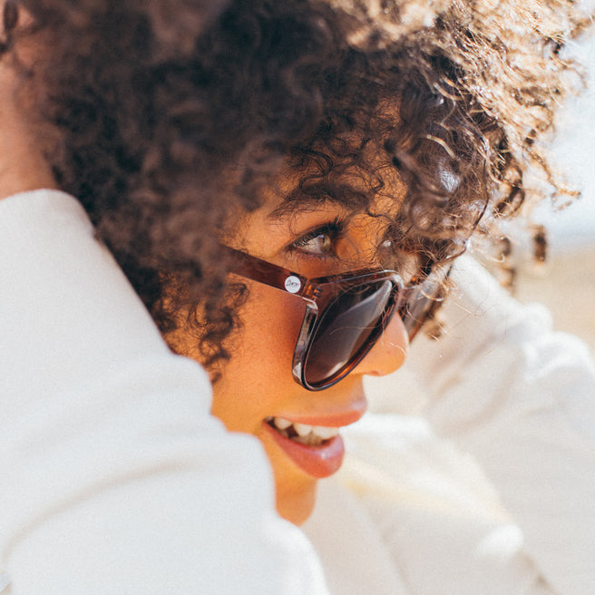 Woman wearing sunglasses with a blurred background