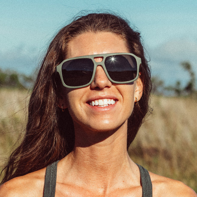 Woman wearing sunglasses with a blurred natural background
