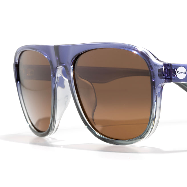 Sunglasses with blue frame and brown lenses on a white background