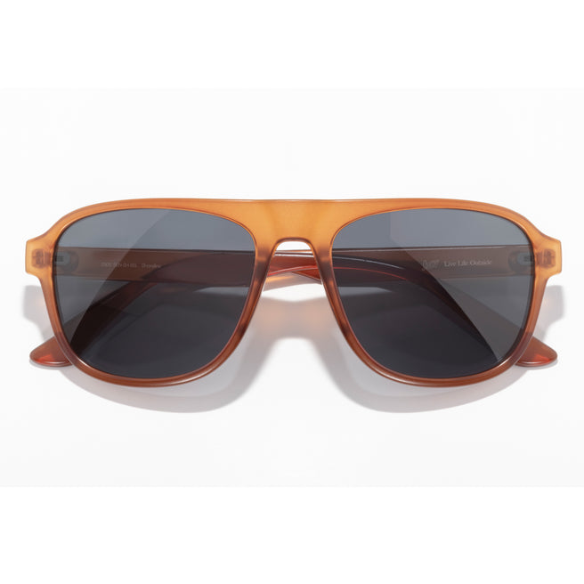 Sunglasses with brown frame and dark lenses on a white background