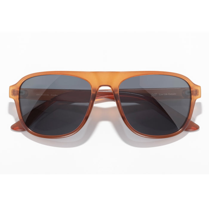 Sunglasses with brown frame and dark lenses on a white background
