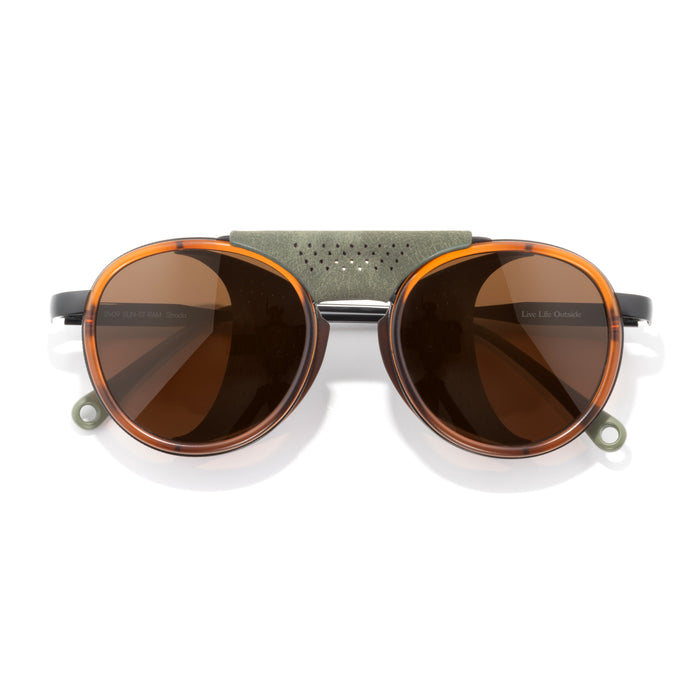 Sunglasses with brown lenses and a metallic frame on a white background