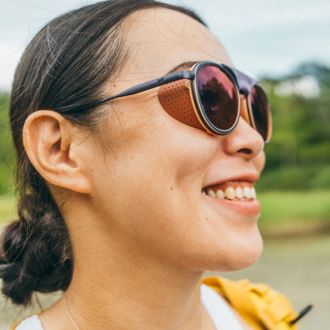 Woman wearing sunglasses with a blurred natural background