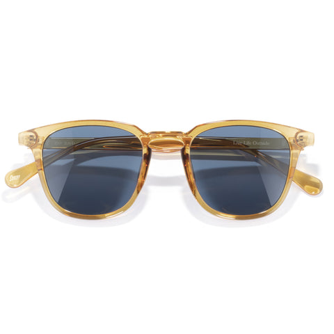 Tango - Cider Midnight - Gold-framed sunglasses with blue lenses on a white background