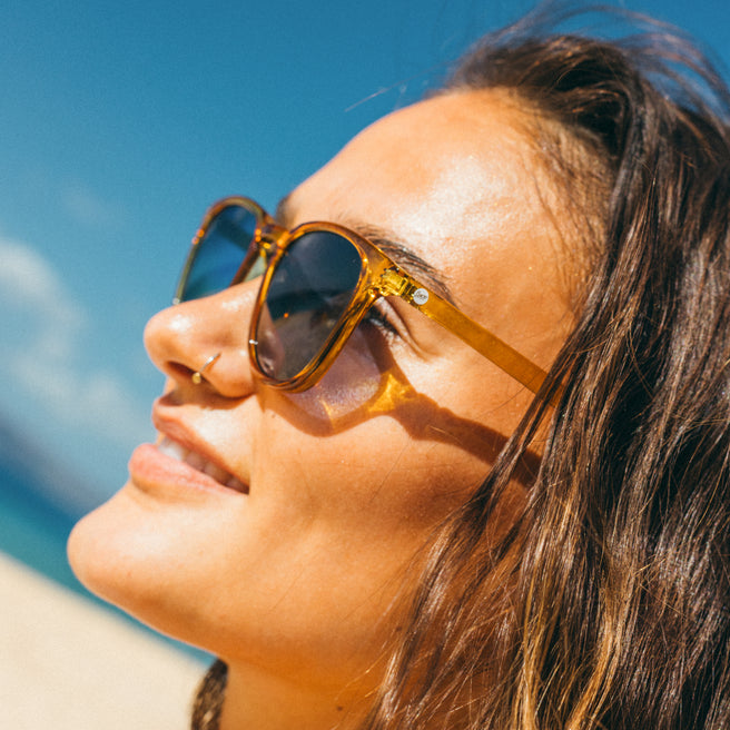 Woman wearing sunglasses with a blue sky background