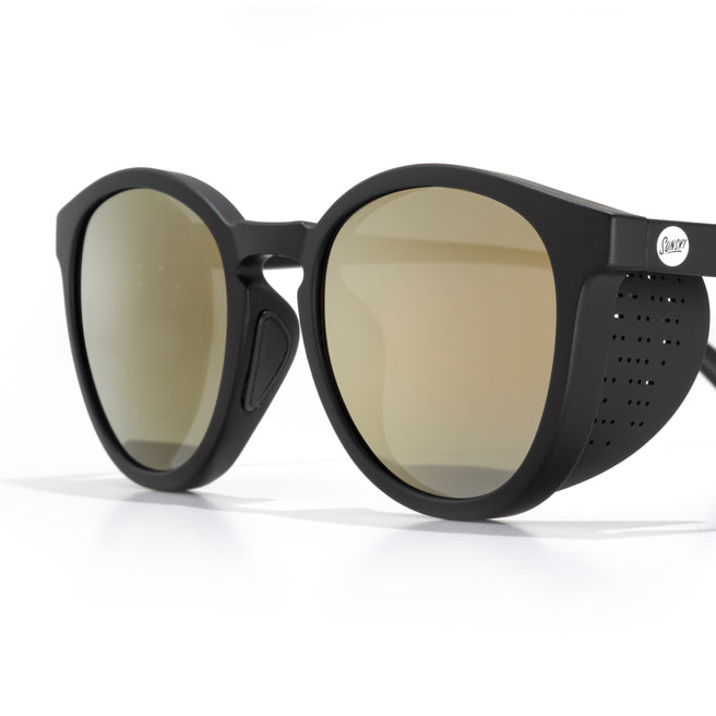 Black sunglasses with gold lenses on a white background