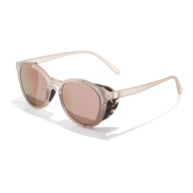 Sunglasses with a tortoiseshell frame and pink-tinted lenses on a white background
