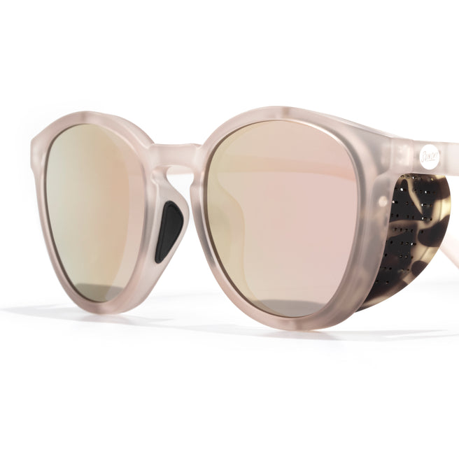 Sunglasses with reflective lenses and a clear frame on a white background