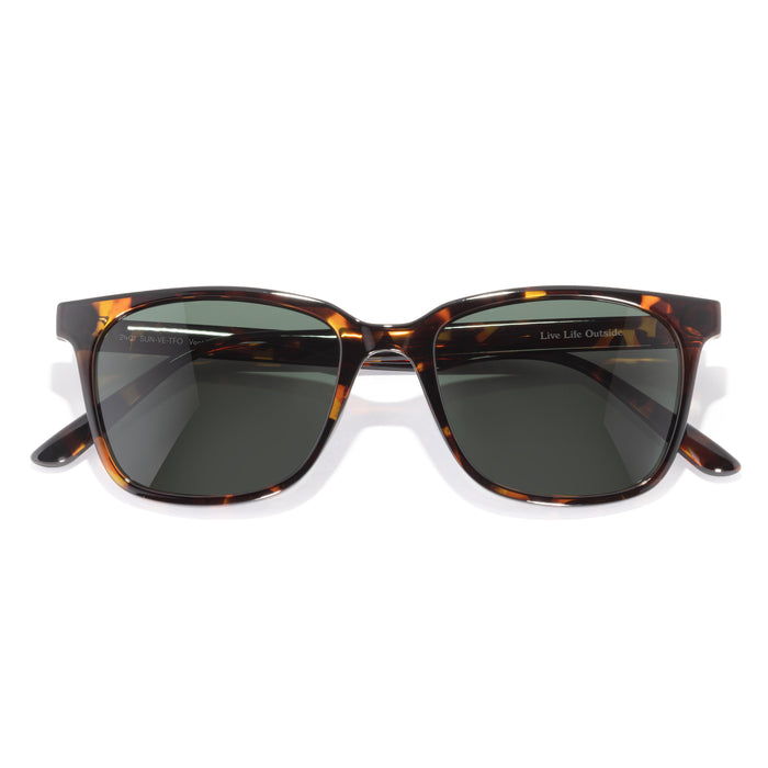 Sunglasses with tortoiseshell frame and dark lenses on a white background