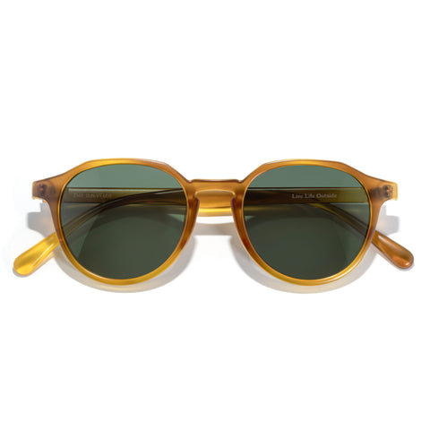 Vallarta - Mellow Yellow Forest - Round sunglasses with gold frame and green lenses on a white background
