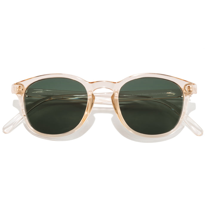 Sunglasses with gold frame and green lenses on a white background
