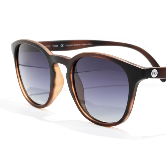 Sunglasses with a brown and black frame on a white background