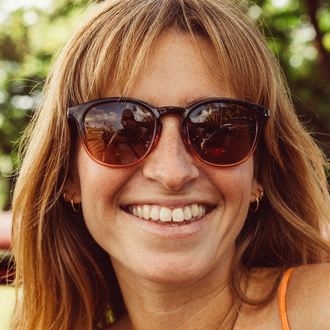 Woman wearing sunglasses with a blurred natural background