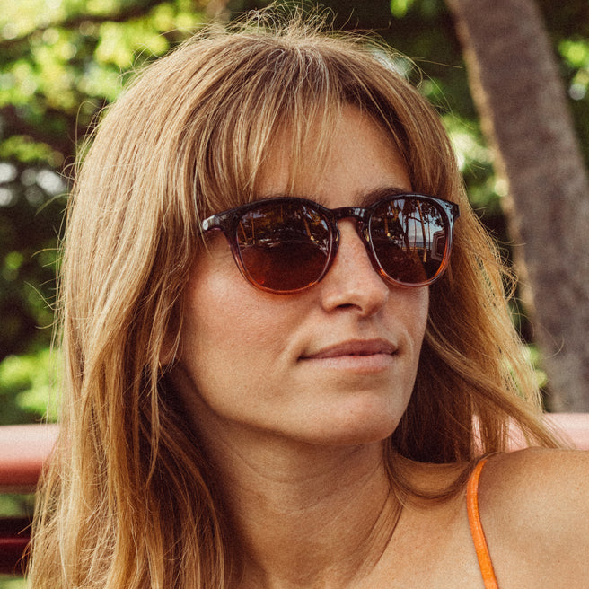 Woman wearing sunglasses with a blurred natural background