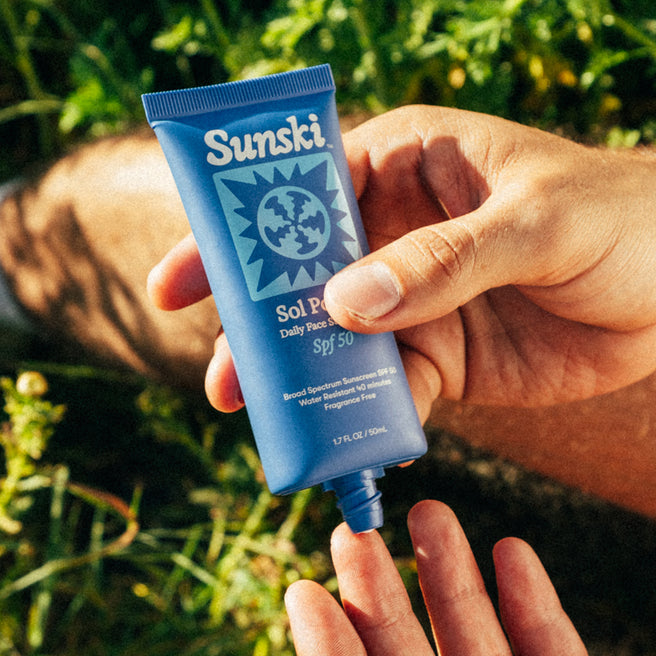 Sol Power SPF 50 Sunscreen - 1.7 Fl oz / 50 mL - Hand holding a blue Sunsiki sunscreen tube against a natural background