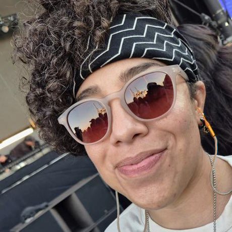 Person wearing sunglasses and a headband with a blurred background